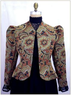 Poly Jacquard. Color: Multi. Beautiful multi color jacquard woven design. Small paisley pattern in gold, black and copper colors. Fitting darts front and back and shoulder pleated Victorian two piece sleeves. Unlined jacket perfect for outdoor wear in all weather. Dry clean. Circa 1890-1905. Made in U.S.A. Sizes: SM, MED LG & XLG. Jackets ordered by bust measurement, inches: BUST         SIZES 32" - 34"   SMALL 35" - 39"   MEDIUM 40" - 44"   LARGE 45" - 49"   XLARGE Jackets ordered by bust measu Edwardian Jacket, Ruffle Long Sleeve Blouse, Victorian Blouse, Formal Shirt Dress, Floral Lace Blouse, Jacquard Jacket, Curated Closet, Velvet Blouses, The Ruins