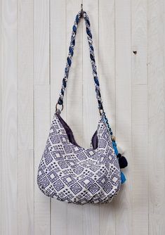 Add a bohemian touch to your ensemble with our mixed media hobo bag in hues of blue. Featuring a snap closure, a twisted strap, and a multi-tassel accent. A fashionable slouchy purse that's perfect for everyday use. Slouchy style bag Mixed media Single snap closure Twisted strap Multi tassel detail Beaded embellishments Dimensions: W: 19 in x H: 12 inStyle: DR-1929 Bohemian Summer Hobo Bag With Removable Pouch, Bohemian Hobo Bag With Removable Pouch For Summer, Bohemian Beach Bag With Detachable Strap, Beach Bohemian Bag With Detachable Strap, Bohemian Shoulder Bag With Braided Handles For Everyday, Hobo Bag With Detachable Strap, Blue Bohemian Bucket Bag With Adjustable Strap, Bohemian Blue Bucket Bag With Adjustable Strap, Blue Bohemian Bucket Bag For Travel