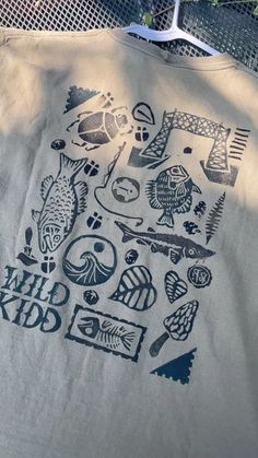 a t - shirt with the words chill city printed on it, and various fish