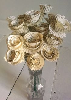 a vase filled with lots of paper flowers