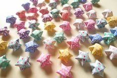 many small origami stars are scattered on the table, including one with dots