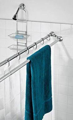 a towel rack in a bathroom next to a bathtub with a blue towel hanging on it