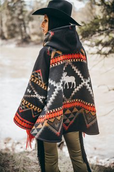 Most Orders Ship within 1-2 Business Days Fully lined bell-shaped hooded cloak with welt patch pockets and three toggle closure. Valentine is 5'11" and wears size OS. Unnapped Pendleton blankets: 82% Wool, 18% Cotton. Wool Cashmere facings and Silk Rayon peachskin lining. Lost Trail Pass traverses the border of Idaho and Montana, high in the Bitterroot Mountains. It was near here that the Lewis and Clark Corps of Discovery crossed into the Bitterroot Valley in September 1905, after successfully Black Winter Cape For Outdoor, Black Winter Outdoor Cape, Winter Outdoor Cape, Nordic Black Outerwear For Fall, Hooded Fall Poncho For Outdoor Activities, Hooded Fall Poncho With Pockets, Nordic Style Black Outerwear For Cold Weather, Hooded Poncho For Fall Outdoor Activities, Black Nordic Winter Outerwear