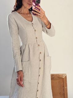 "* 100% soft linen  * V-neck * Long sleeve  * Pockets  * The waist can be adjusted by a linen tie at the back * Handmade in Slovakia   * The model is 5'12\"/ 184 cm tall: - wearing size S, color beige/white gingham  (altered length + 10 cm/ 4\"),  - wearing size S, color forest green, standard length    Measurements in inches/cm: Size XS Recommended body measurements for a fitted look: Bust: 31\"- 32\"/ 78 - 82 cm Waist: 25,5\"- 26,5\"/ 65 - 68 cm Hips: 33\"-34\" / 84 - 87 cm   - cloth (laid on the floor):  Bust: 16\"/ 41 cm  Length (from the neckline to the hem measured from the back): 41,5\"/ 105 cm  Length from shoulder to waistline: 14\"/ 36 cm  ---------------------------  Size S Recommended body measurements for a fitted look: Bust: 33,5\" - 34,5\" /85 -88 cm Waist: 27\" - 28,5\"/69 V-neck Linen Dress With Buttons, Long Sleeve Linen Dress With Buttons For Work, Chic Long Sleeve Beige Linen Dress, Chic Beige Linen Long Sleeve Dress, Beige Long Sleeve Linen Dress For Spring, Beige Linen Long Sleeve Dress For Fall, Casual V-neck Linen Dress For Fall, Casual Beige Long Sleeve Linen Dress, Beige Long Sleeve Casual Linen Dress