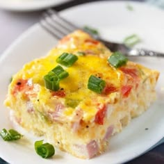 a close up of a plate of food with broccoli and ham casserole