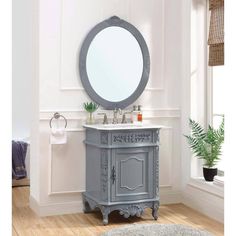 a bathroom vanity with a round mirror above it and a rug on the floor next to it