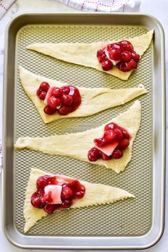 cranberry and cream filled pita bread on a baking sheet