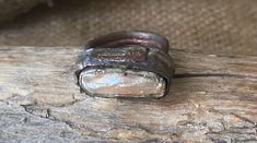 a piece of metal sitting on top of a wooden table