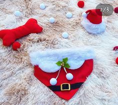 a santa claus hat and dog collar laying on top of a furry rug