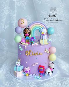 a birthday cake decorated with toys and balloons