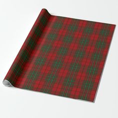 a red and green plaid wrapping paper on a white surface with a black border in the middle