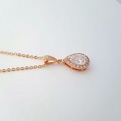 Dainty and small gold wedding pendant necklace with Cubic Zirconia tear drop set in an open setting. Will also work great as a bridesmaid necklace or gift. Created with 14k Gold plated brass bezel and surrounded by tiny cubic zirconia crystals, it is 12mm in size. I have put it onto a cubic zirconia detailed bail in gold plated brass and finished with a gold plated chain. Chain length is available in two sizes, 16 inches and 18 inches and both come with an additional 2 inches extension chain. Ma Rose Gold Drop Necklace For Wedding, Elegant Gold Pear-shaped Bridal Necklace, Rose Gold Teardrop Bridal Necklace Gift, Rose Gold Teardrop Bridal Necklace, Gold Cubic Zirconia Teardrop Bridal Necklace, Delicate Rose Gold Drop Necklace For Wedding, Gold Teardrop Pendant Bridal Necklace As Gift, Delicate Gold Drop Necklace For Wedding, Gold Drop Bridal Necklace Gift