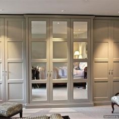 a bedroom with mirrored closet doors and furniture