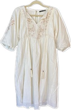 White Embroidered Dress For Daywear, White Embroidered Hem Dress For Daywear, White V-neck Embroidered Dress For Brunch, Off White Embroidered Beach Dress, Embroidered Off-white Beach Dress, White Cotton Embroidered V-neck Dress, Casual Embroidered Cream Dress, Off White Floral Embroidery Dress For Brunch, Cream Embroidered Dress For Brunch