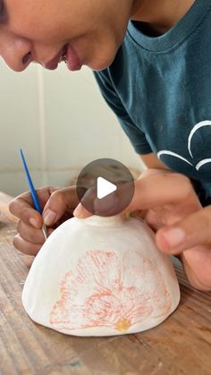 a young man is working on a clay sculpture