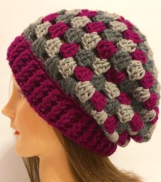 a crocheted hat is on top of a mannequin's head