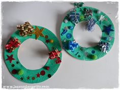 two paper plate christmas wreaths with bows on them