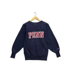 "Code : p/496 Vintage 90s Champion Reverse Weave Penn State Navy Sweatshirt Small Nittany Lions Sweater Pullover Penn State University Patches Logo Jumper Size on Tag :  S Details Measurement  Arm Pit to Arm Pit : 20\"inches Back Collar to Hem : 27\"inches Condition :  Great Vintage Condition(Used Clothing).No Holes And No Stain.Please refer pictures detail.‼️" Vintage Cotton Sweatshirt For Campus, 90s Style Relaxed Fit Sweatshirt For College, Vintage Crew Neck Tops For Campus, Vintage Winter Campus Sweatshirt, 90s Style Tops With Ribbed Cuffs For College, Vintage Sweatshirt With Letter Print For Campus, 90s Crew Neck Winter Tops, 90s Long Sleeve Sweater With Letter Print, 90s Style Crew Neck Top For Fall