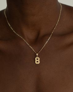 Numbers don't lie. Rep your favorite digit, your lucky number, or any number you see fit with The Number Necklace. One intricately detailed block number hangs on our classic 2.5mm Figaro Chain and is removable + interchangeable. This signature piece is a cool and personal addition to your stack (especially if you already have a name/initial necklace) and is one you can keep forever. Number 7 Necklace, Piercing Inspo, Signature Necklace, Number Necklace, Gold Locket, Lucky Number, Figaro Chains, Figaro Chain, Hearts Desire