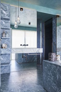 a bathroom with blue marble walls and flooring