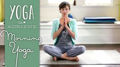 a woman sitting on top of a yoga mat with her hands clasped in front of her face