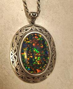 "Beautiful Black Opal Vintage Style Necklace, Huge 18x25mm Lab Created Favorite Opal, See Video! Photos Taken In Natural As Well As Indoor Lighting. Antiqued Sterling Silver Vintage Style Pendant, 20\" Matching Sterling Chain. Gift Box Included.  *This One Is For Lovers Of Big Bold Jewelry, Make Sure Recipient Is That Person! I Have This Stone In A Simple Pendant Also" Multicolor Hallmarked Necklaces As Gift, Multicolor Hallmarked Necklace For Gift, Oval Multicolor Jewelry For Formal Occasions, Multicolor Jewelry With Large Stone For Gift, Multicolor Cabochon Round Pendant Jewelry, Multicolor Large Stone Jewelry Gift, Multicolor Oval Spiritual Jewelry, Multicolor Oval Spiritual Necklaces, Spiritual Oval Multicolor Necklaces