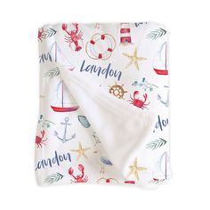 a white blanket with an anchor, crab and starfish print