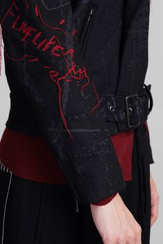 Biker jacket in black wool, large revers, long sleeves, zip closure, belt waist, embroidery on sleeve, side pockets, back embroidery, 80% wool, 10% poliestere, 5& acylic, 5% nylon, fully lined, 100% cupro, Made in Japan, Model is 180 cm and wears a size 1 Black Wool Coat With Belted Cuffs, Black Wool Coat With Belted Cuffs For Winter, Black Blazer With Belted Cuffs, Black Blazer With Belted Cuffs And Long Sleeves, Black Long Sleeve Blazer With Belted Cuffs, Black Winter Outerwear With Belted Cuffs, Black Belted Wool Coat For Fall, Black Belted Wool Coat, Fitted Black Belted Wool Coat