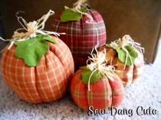 three pumpkins are sitting on the floor together