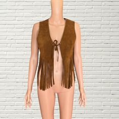 Vintage 60s - 70's Tan Beaded Suede Fringe Vest Boho Western style cropped length vest  tan brown suede leather fabric  Gold beaded trim  front tie closure  Brand: Mr Leather good condition, some general wear as pictured Measurements: Length: 22" Pit to pit: 18" Hippie Style Fitted Sleeveless Vest, Fitted Sleeveless Hippie Vest, Western Style Sleeveless Vest For Spring, Fitted Fringe Vest, Hippie Style Vest For Fall Festival, Western Style Fitted Vest For Spring, Fitted Western Vest For Spring, Spring Fitted Western Vest, Fitted Sleeveless Vest With Fringe