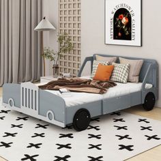 a child's bedroom with a toy car bed in the middle and rug on the floor