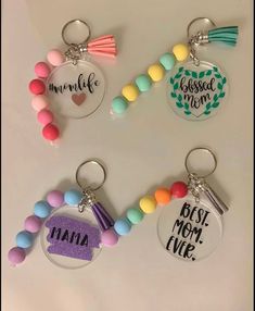 four keychains with different designs on them and some beaded charms attached to them