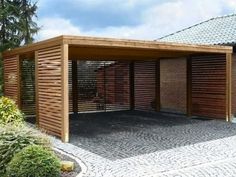 an outdoor pavilion with wooden slats on the sides and brick pavers flooring