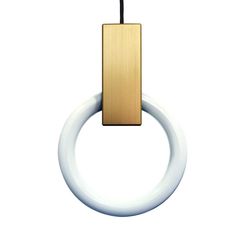 a white and gold ring with a black cord hanging from it's end, in front of a white background