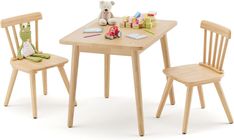 a wooden table with two chairs and a teddy bear