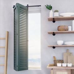 a kitchen with open green shutters and shelves on the wall next to a window