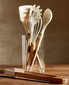 kitchen utensils in a glass with wooden spoons