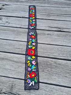 Dress up any outfit in your wardrobe with beautiful embroidered accessories! Add interest to a casual outfit with a beautiful belt. Embroidered by hand in Hungary, Kalocsa city.  This is an unique handmade work. This is a perfect gift for friends and for your family. Original Kalocsa work! lenght , 32,5" width , 2,5" If you are buying several pieces I can combine postage at the time of mailing. If you have any question please don't hesitate to contact me For vintage Hungarian emboridery please visit our other shop: https://www.etsy.com/shop/TreasuryCoffer?ref=l2-shopheader-name Handmade Bohemian Belt With Multicolor Embroidery, Bohemian Embroidered Belt For Spring, Bohemian Multicolor Embroidery Belts For Festival, Bohemian Embroidered Belts With Multicolor Embroidery, Bohemian Black Embroidered Belt, Black Bohemian Embroidered Belt, Belt Embroidery, Embroidered Accessories, Embroidery Belt