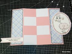 a pink and white card with a sheep on it