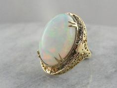 Vintage 14k Stamped Opal Ring For Formal Occasions, Classic Oval Hallmarked Opal Ring, Heirloom Oval Opal Ring For Formal Occasions, Classic Cabochon Opal Ring For Formal Occasions, Classic Oval Opal Ring Collectible, Classic Opal Ring, Oval Filigree Ring With 17 Jewels For Anniversary, Classic Domed Collectible Jewelry, Vintage White Opal Ring For Formal Occasions