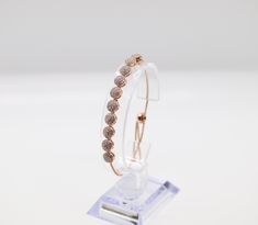 This bracelet is made of rose gold, which is a beautiful and durable material. The bracelet is designed to be worn by women and is available in a variety of sizes to ensure a comfortable fit. The bracelet is adorned with a delicate pattern that adds a touch of elegance to any outfit.