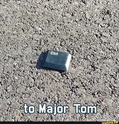 a computer chip laying on the ground with words that read to major tom below it