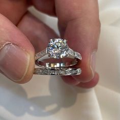 a close up of a person holding a diamond ring