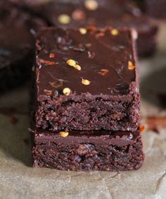 two pieces of chocolate brownie sitting on top of each other