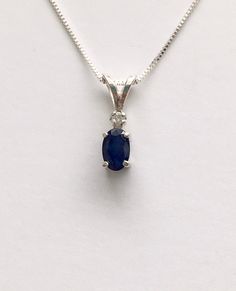 Genuine small dark sapphire measures 6x4mm (1/2 carat). Genuine 2mm accent diamond. Both handset in sterling silver. Sterling silver box chain is 18 inches long and can be switched out to a 16 inch chain upon request.Necklace is perfect for a child or the minimalist. Comes in a gift box Ruby Heart Necklace, Purple Stone Necklace, Sapphire Diamond Necklace, September Birthstone Necklace, Smoky Quartz Jewelry, Necklace Sapphire, February Birthstone Necklace, Sapphire Diamond Pendant, Red Heart Necklace