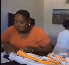 a woman sitting at a table with some food