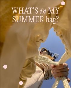 a person holding a rope with the words what's in my summer bag?