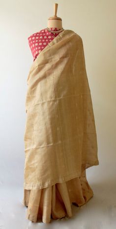 "This is a Handloom, Hundred Percent Pure Muga Silk Saree from the looms of ASSAM.  The Saree is more contemporary than traditional as it has been woven in the lightweight manner so that it is easier to wear and handle. There are small all over motifs in muga ghicha . It is very subtle .  Muga Silk - The most valued silk from India. Almost exclusively reared and produced in Assam, India. It is indigenous to the Brahmaputra Valley and assiduously practiced in the districts of Assam. The moth is b Traditional Drape Blouse With Woven Motifs, Traditional Ceremonies Woven Motifs Blouse Piece, Transitional Blouse Piece With Traditional Drape And Woven Motifs, Transitional Season Traditional Drape Blouse Piece With Woven Motifs, Beige Handloom Traditional Dupatta, Festive Beige Handloom Dupatta, Beige Handloom Dupatta For Festivals, Transitional Blouse Piece With Weaving Work And Traditional Drape, Muga Silk Saree