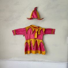 Hello and welcome to the Textile Trunk! Please follow us on Instagram, we are @textiletrunk  I've just returned from a European buying trip and this is one of the my amazing finds This sweet outfit I found in France and it dates from 1920-1930's , it's mostly hand stitched! It's a wonderful pink and yellow jester's skirt for a girl. Gold metallic trim and lovely metal bells and it's hand stitched!  ~ it's all cotton , wonderful find! The hat is great, it kicks out at the bottom ~ ideal for frami Pink Costume Dress For Carnival, Medieval Jester, Jester Outfit, Jester Hat, Amazing Finds, French Girls, Dress Costume, Pink And Yellow, Women's Costumes