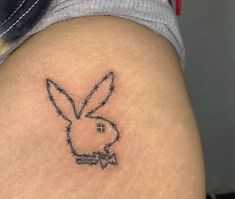 a tattoo on the back of a woman's thigh that has barbed wire and a bunny face